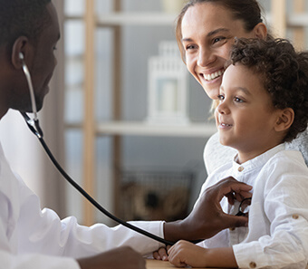 Child receiving a well-child checkup during an annual physical